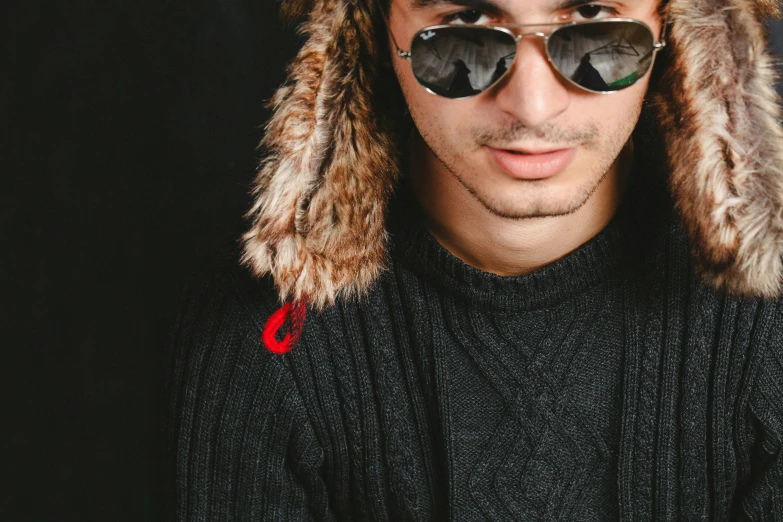 a man wearing a fur hat and sunglasses, a character portrait, trending on pexels, hurufiyya, young man with short, saadane afif, hibited, chilly