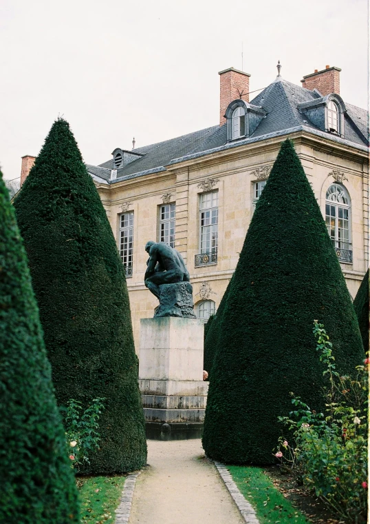 a large building with a statue in front of it, inspired by Henri Alphonse Barnoin, unsplash, paris school, trees and bushes, kodak portra, thoughtful ), toad philosopher the thinker