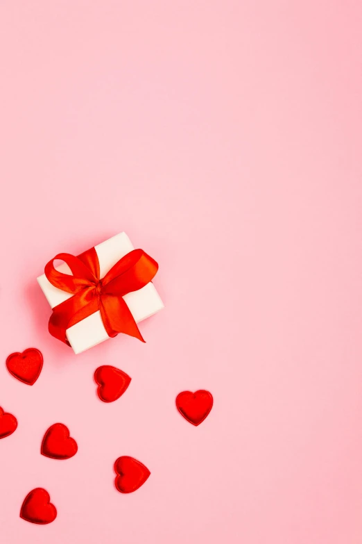 a white gift box with red hearts on a pink background, pexels contest winner, alexis franklin, square, bows, of