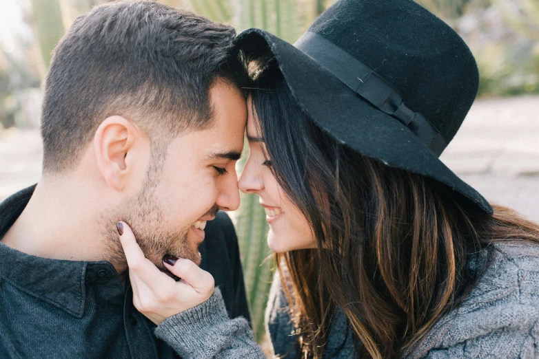 a man and a woman standing next to each other, trending on pexels, romanticism, wearing a cute hat, spiky, smelling good, date