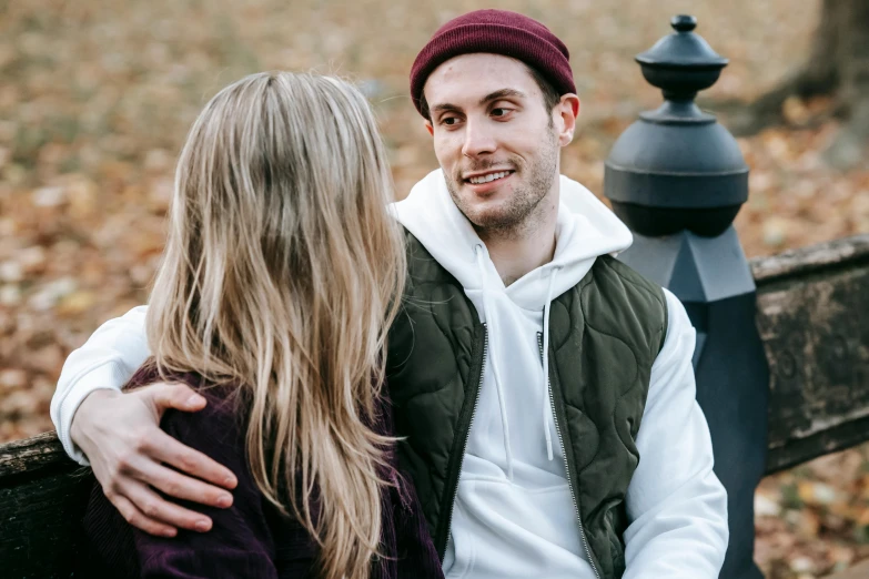 a man and a woman sitting on a bench, trending on pexels, wearing a purple breton cap, casey cooke, wearing beanie, product introduction photo