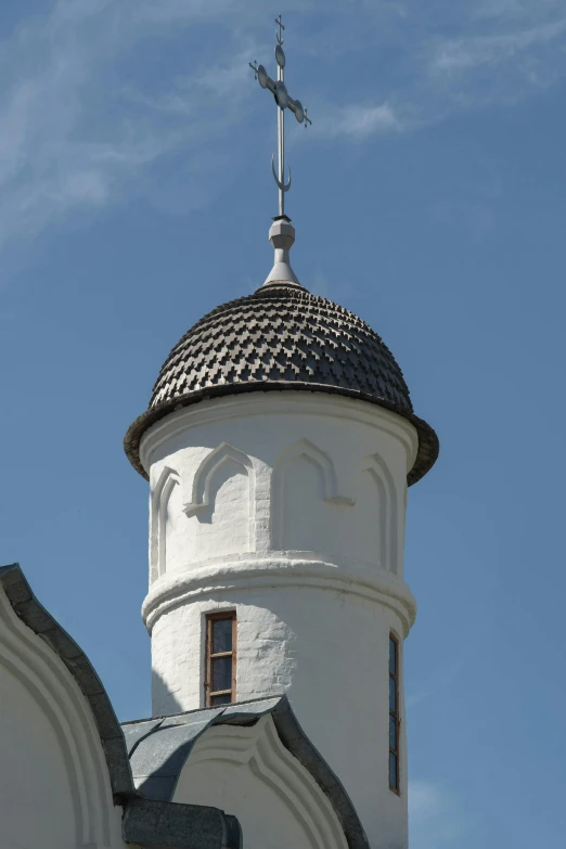 a clock tower with a cross on top of it, inspired by Oluf Høst, art nouveau, rounded roof, museum, white, mosque