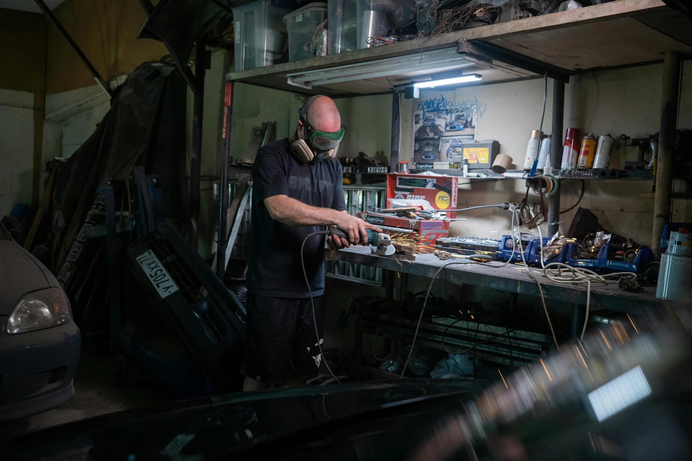 a man working on a car in a garage, pexels contest winner, in his basement studio, glass oled mecha visor, laquer and steel, restomod