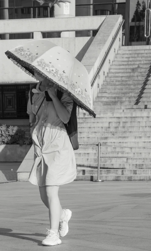 a black and white photo of a woman with an umbrella, inspired by Ruth Orkin, conceptual art, 8 k photo, pose 4 of 1 6, japanese woman, metropolitan museum photo