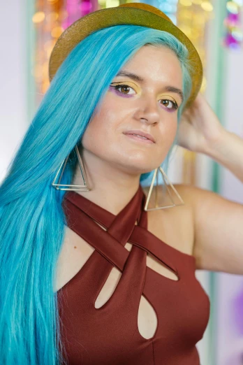 a woman with blue hair wearing a hat, an album cover, inspired by Glòria Muñoz, featured on reddit, bright gold long hair, twitch streamer, pose 4 of 1 6, vibrant color!