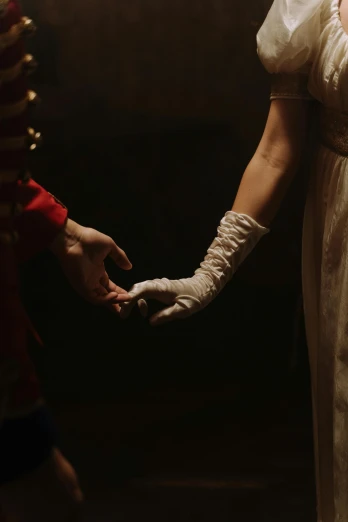 a woman in a white dress holding a man's hand, an album cover, inspired by Pietro Longhi, pexels, napoleonic wars, low light cinematic, 4 k film still, wearing gloves
