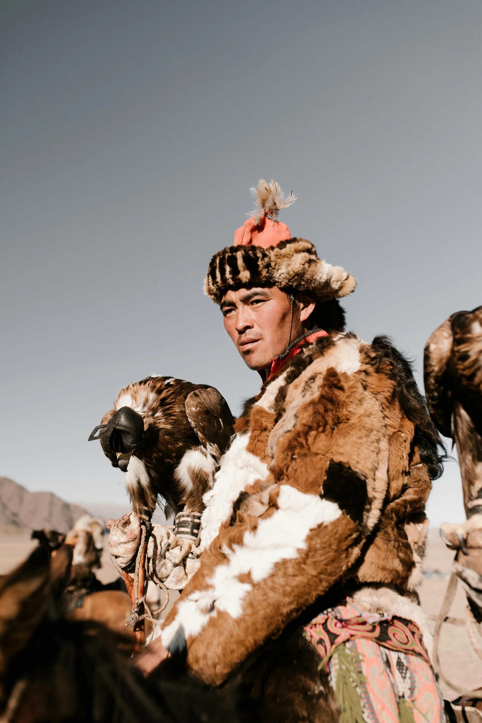 a man riding on the back of a brown horse, an album cover, by Shang Xi, trending on unsplash, hurufiyya, wearing fur armor, ethnic group, looking confident, full frame image