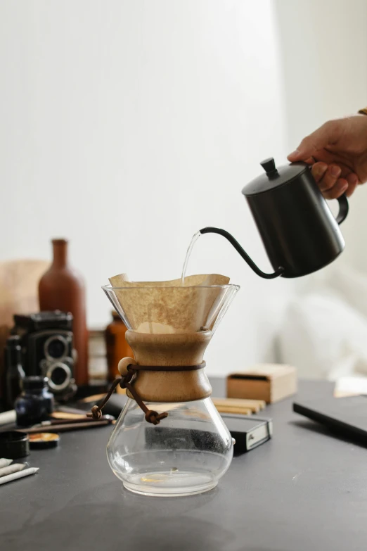 a person pours water into a coffee pot, a still life, trending on unsplash, cone shaped, deus ex machina, dwell, thumbnail