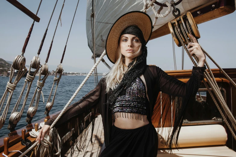 a woman that is standing on a boat, a portrait, by Emma Andijewska, pexels contest winner, renaissance, hippie fashion, black clothing, wearing a crop top, arabian nights inspired