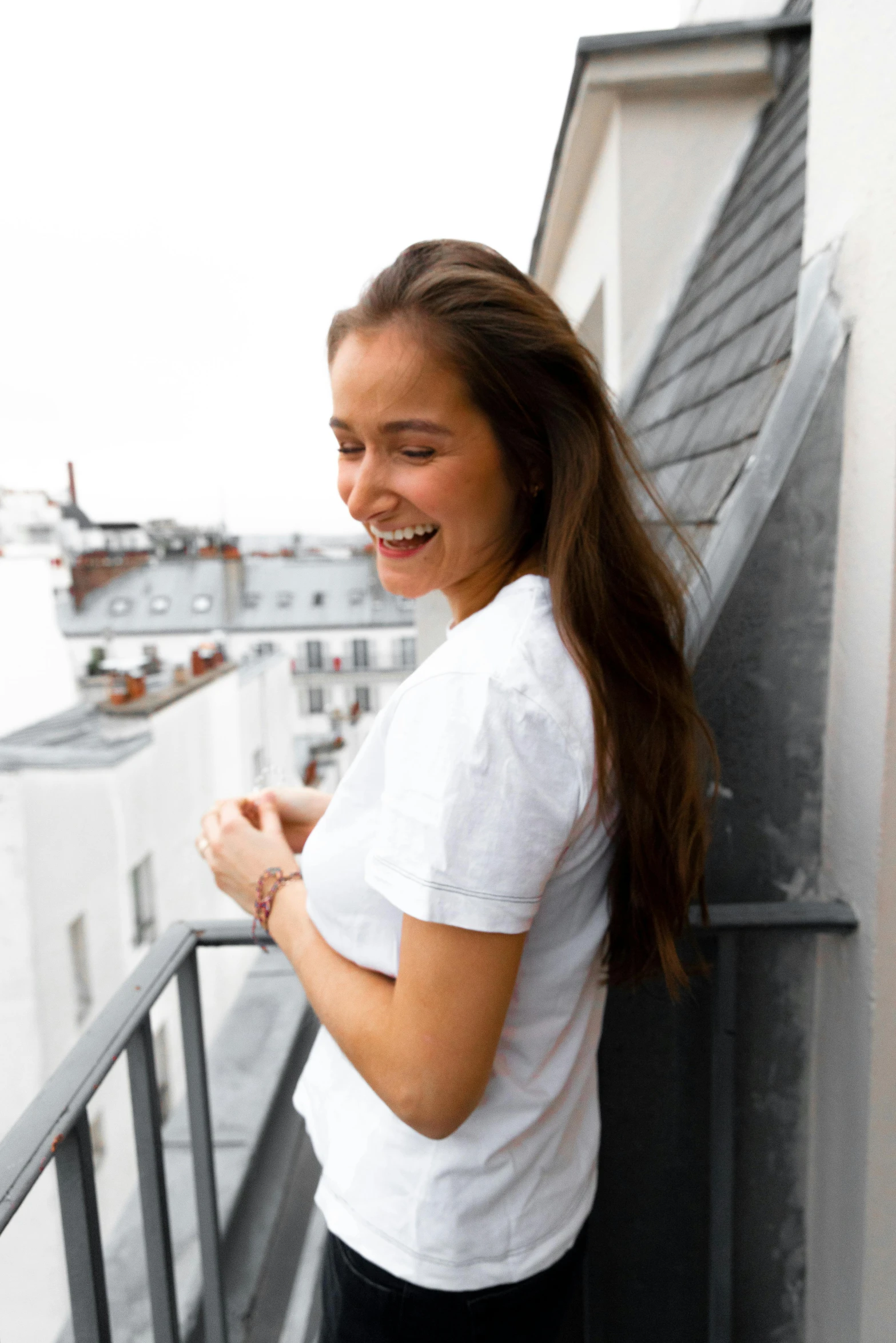 a beautiful young woman standing on top of a balcony, by Maud Naftel, pexels contest winner, happening, earing a shirt laughing, alicia vikander, young woman with long dark hair, paris