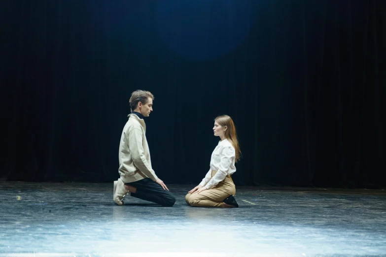 a man and a woman sitting on a stage, by Grytė Pintukaitė, unsplash, renaissance, sitting on the floor, facing each other, ( ( theatrical ) ), anna kovalevskaya