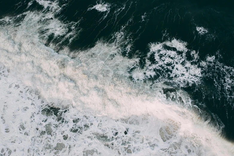 a person riding a surfboard on top of a body of water, satellite view, turbulent sea, unsplash 4k, ignant