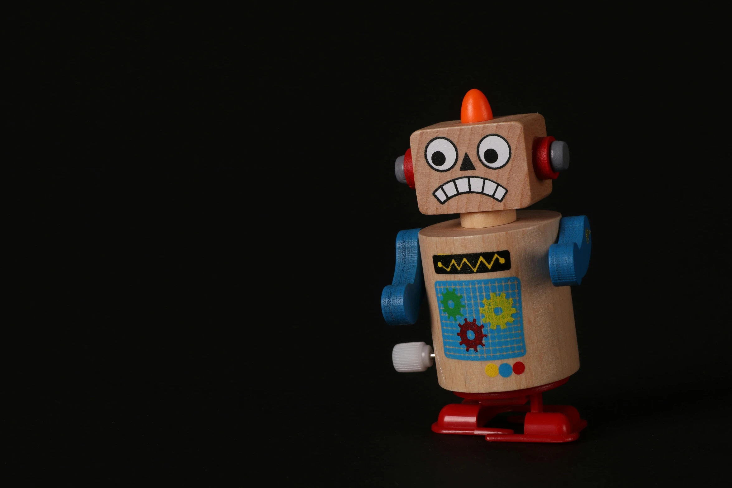 a close up of a toy robot on a black background, an album cover, unsplash, wooden, annoyed, tourist photo