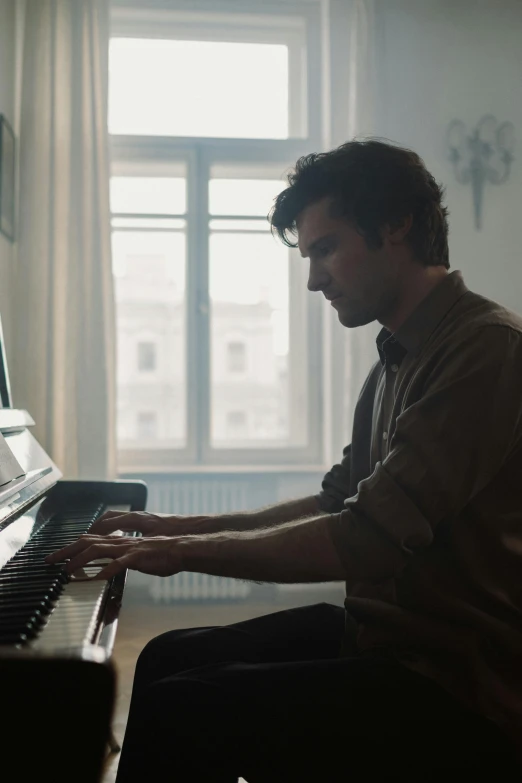 a man sitting at a piano in front of a window, 4 k movie still, romantic lead, shot with sony alpha, eng kilian