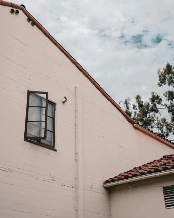 a white house with a red tiled roof, an album cover, unsplash, modernism, window, discovered photo, wall corner, very accurate photo