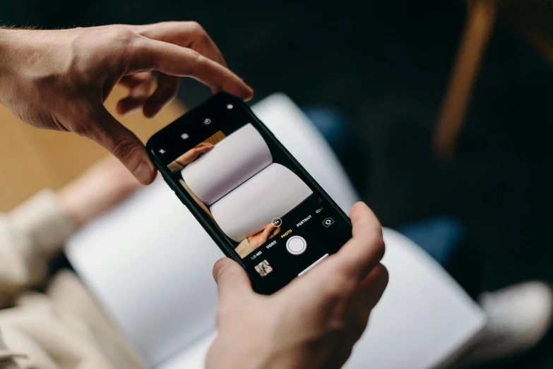 a close up of a person holding a cell phone, a picture, trending on pexels, on high-quality paper, avatar image, medium format, high quality image