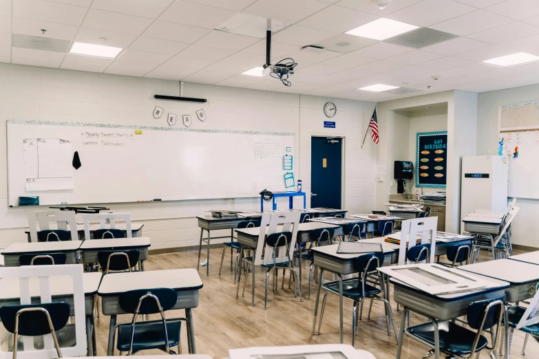 a classroom filled with lots of desks and chairs, a portrait, unsplash, northwest school, background image, standing in corner of room, american school, music video