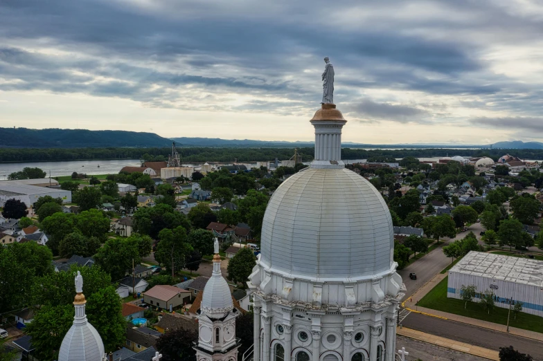 a view of a city from the top of a building, by Greg Rutkowski, unsplash contest winner, renaissance, upon a peak in darien, neoclassical tower with dome, minn, 4k photo gigapixel