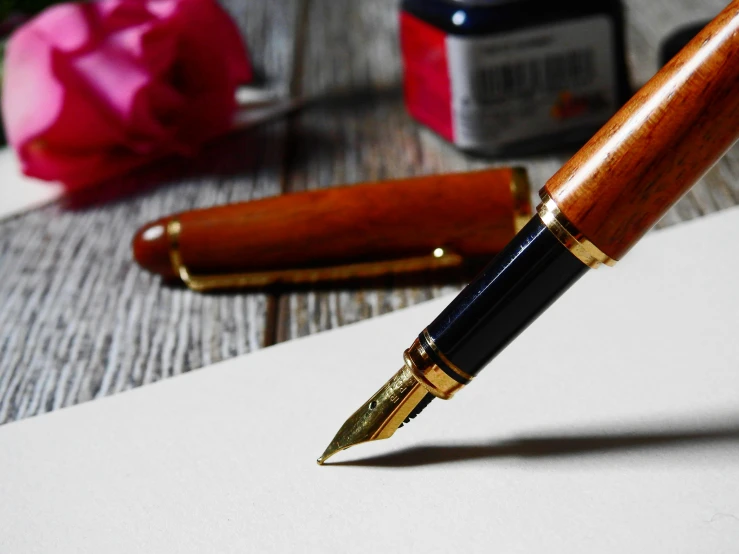 a fountain pen sitting on top of a piece of paper, a still life, by Sylvia Wishart, unsplash, a wooden, crafts, glossy finish, thumbnail