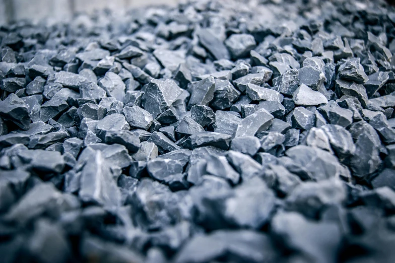 a pile of coal sitting on top of a table, unsplash, ((rocks)), blue gray, terrazzo, close up shots