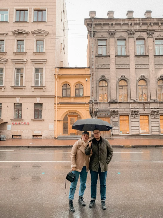 two people standing under an umbrella in the rain, a photo, russia in 2 0 2 1, the neat and dense buildings, non-binary, cold as ice! 🧊