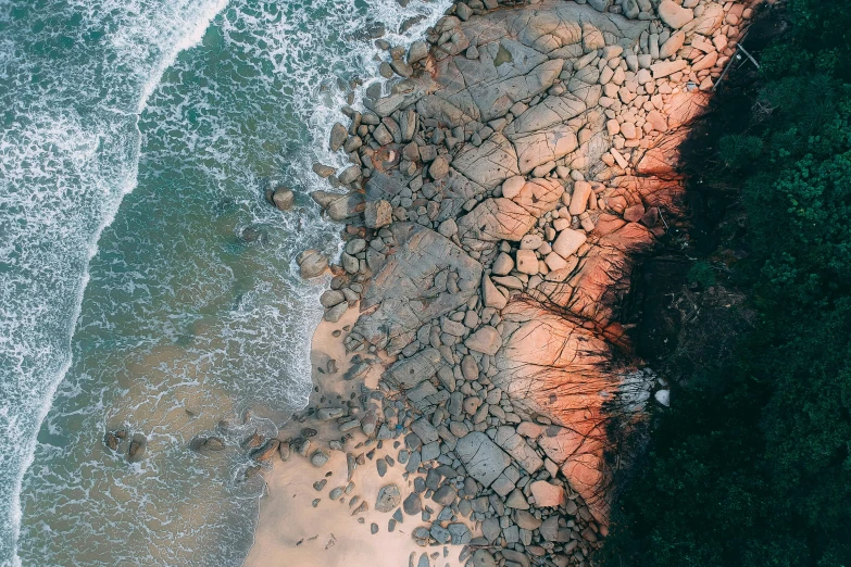 a bird's eye view of a rocky beach, pexels contest winner, warm coloured, “ iron bark, high light on the left, textured skin