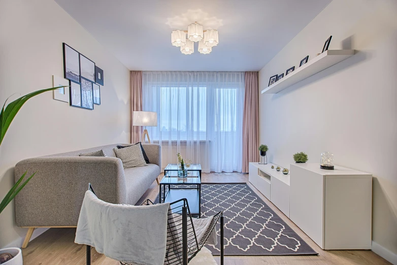 a living room filled with furniture and a large window, by Adam Marczyński, pexels contest winner, light and space, modern pastel colours, charcoal and silver color scheme, suspended ceiling, small and cosy student bedroom