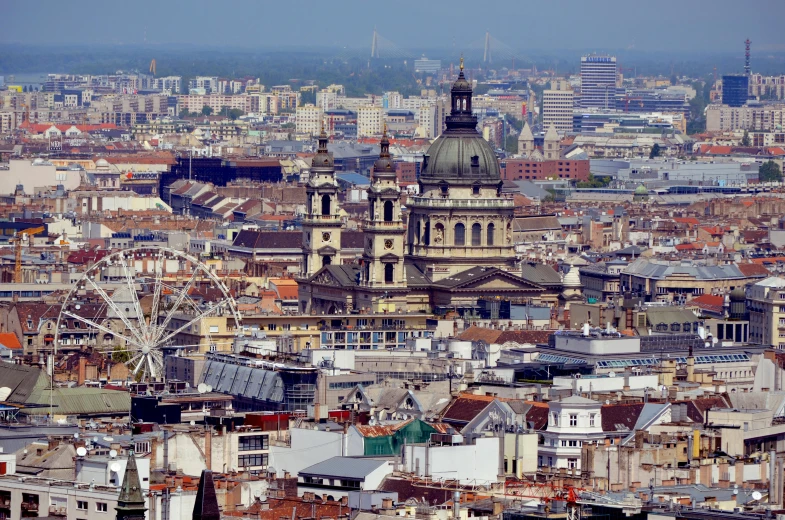 a view of a city with a ferris wheel in the foreground, a photo, by Bertalan Székely, shutterstock, baroque, tiled roofs, 15081959 21121991 01012000 4k, square, domes