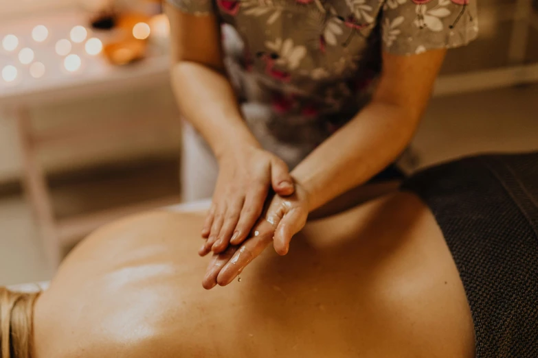 a woman getting a back massage at a spa, by Emma Andijewska, unsplash, fan favorite, lachlan bailey, low quality photo, thumbnail