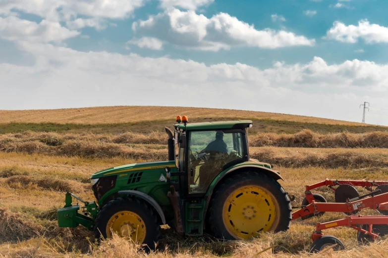 a tractor that is sitting in the grass, by Adam Marczyński, pexels contest winner, working out in the field, avatar image, panoramic, organic biomass