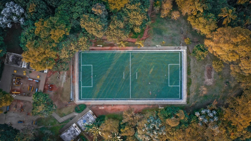 an aerial view of a tennis court surrounded by trees, by Marshall Arisman, unsplash contest winner, on a soccer field, sao paulo, square, sri lanka
