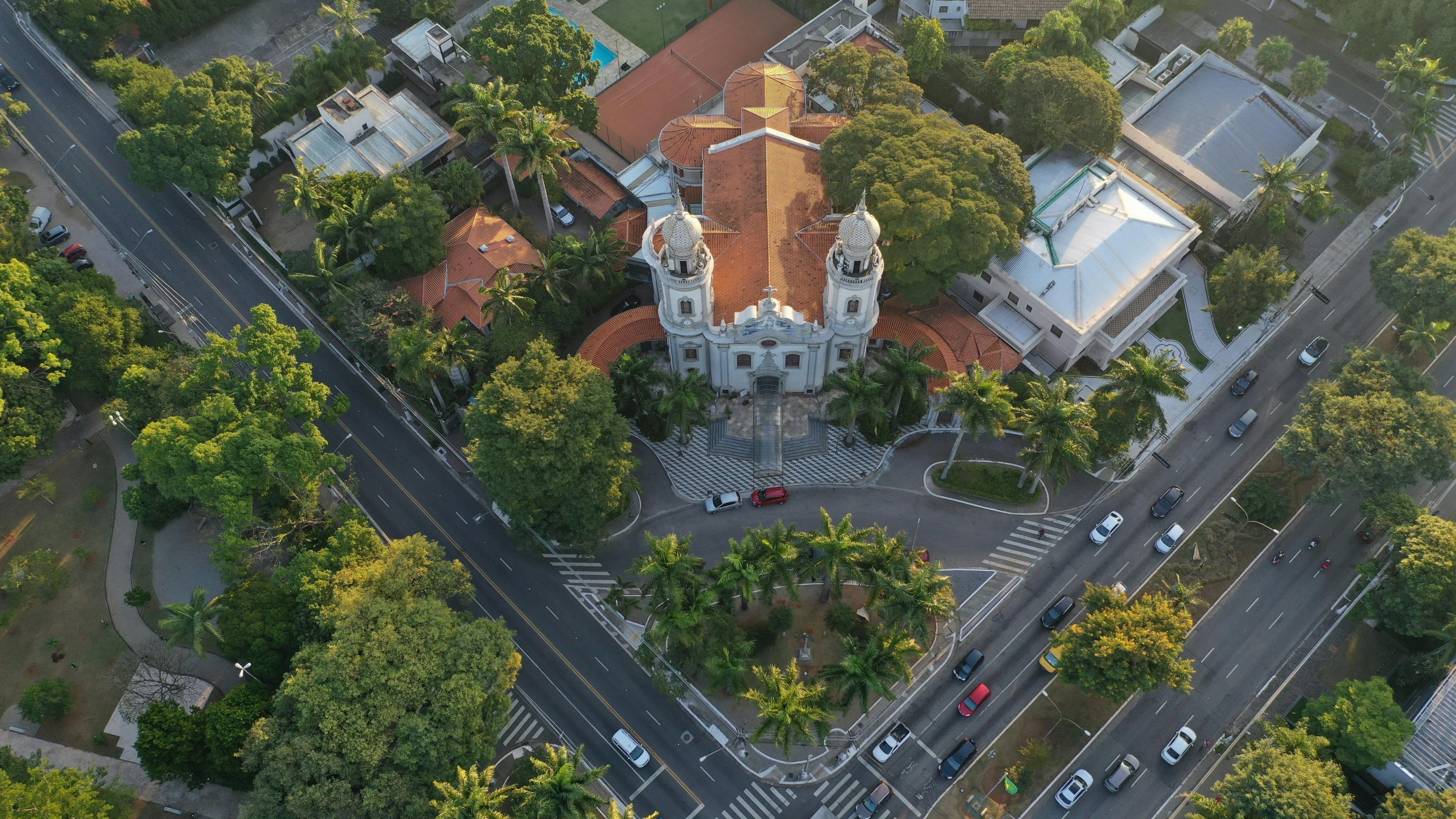 an aerial view of a church surrounded by trees, pexels contest winner, art nouveau, outdoors tropical cityscape, square, colonial, intersection