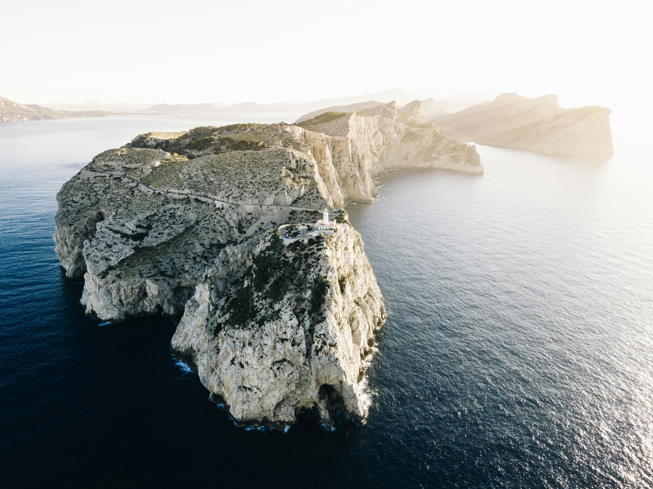 a large body of water next to a cliff, pexels contest winner, hyperrealism, flying island, costa blanca, white, black