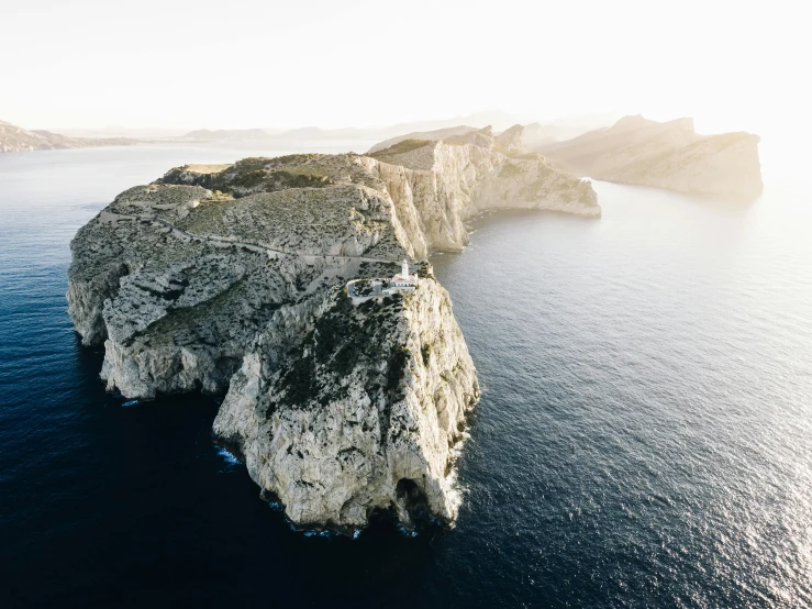 a large body of water next to a cliff, pexels contest winner, hyperrealism, flying island, costa blanca, white, black