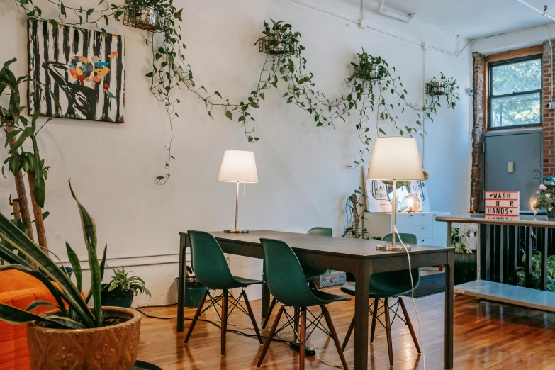 a living room filled with furniture and plants, by Rose O’Neill, trending on unsplash, light and space, multiple desks, mission arts environment, long table, lush brooklyn urban landscaping