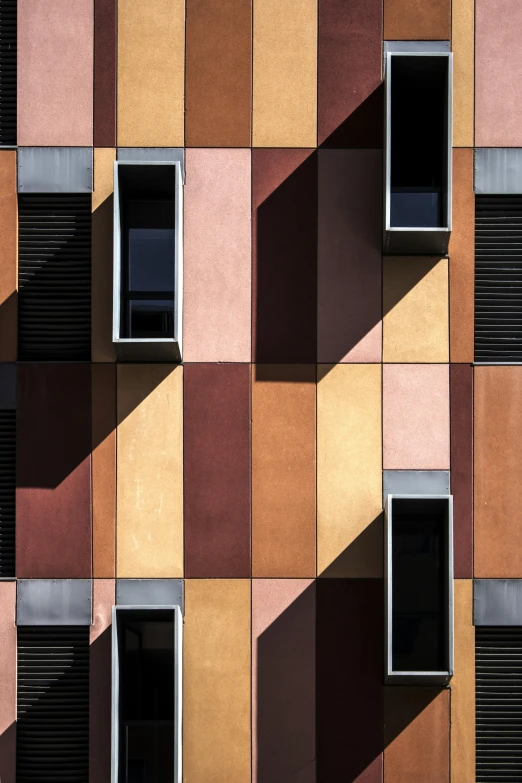 a multicolored building with windows and shutters, inspired by Bauhaus, unsplash contest winner, detailed shadows and textures, square shapes, peter guthrie, high-angle