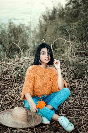 a woman sitting on the ground smoking a cigarette, an album cover, inspired by Elsa Bleda, pexels contest winner, hurufiyya, long orange sweatshirt, sarah andersen, beautiful iranian woman, fluffy orange skin