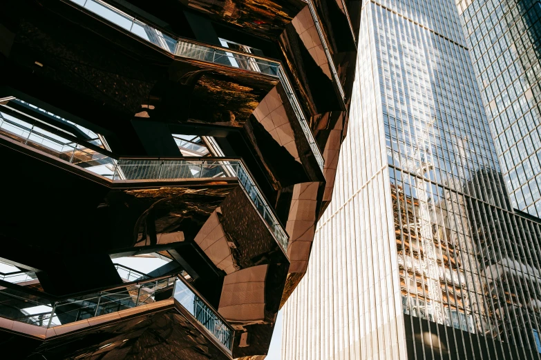 a tall building sitting next to a tall building, inspired by William Berra, unsplash contest winner, brown exoskeleton, metallic bridge, glossy intricate design, ignant