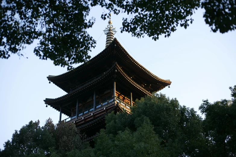 a tall pagoda sitting on top of a lush green forest, unsplash, shin hanga, late summer evening, square, chinese building, 2 0 0 0's photo