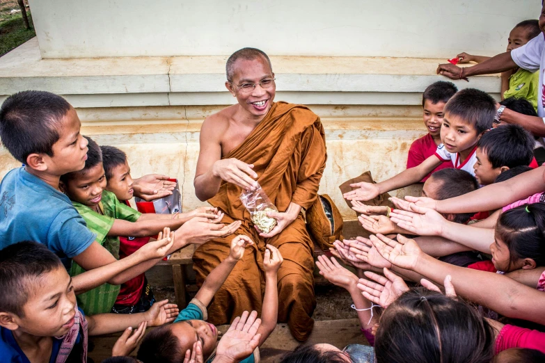 a monk is surrounded by a group of children, pexels contest winner, feeds on everything, avatar image, high resolution photo, serene smile