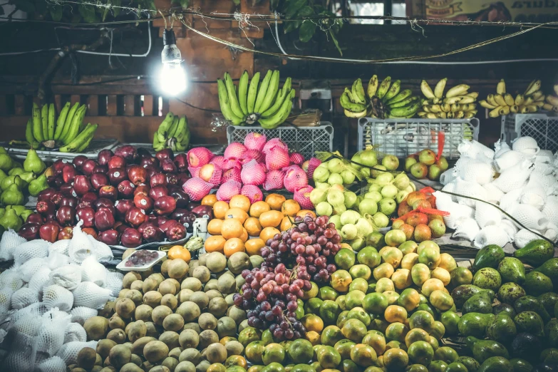a market filled with lots of fruits and vegetables, by Daniel Lieske, pexels, colombia, fan favorite, dazzling lights, colourful apples