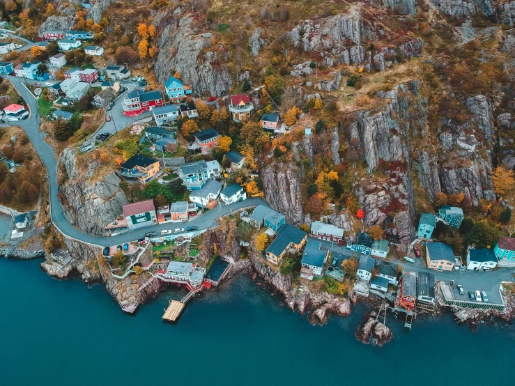 an aerial view of a small town next to a body of water, by Ejnar Nielsen, pexels contest winner, coastal cliffs, canada, colorful caparisons, videogame still