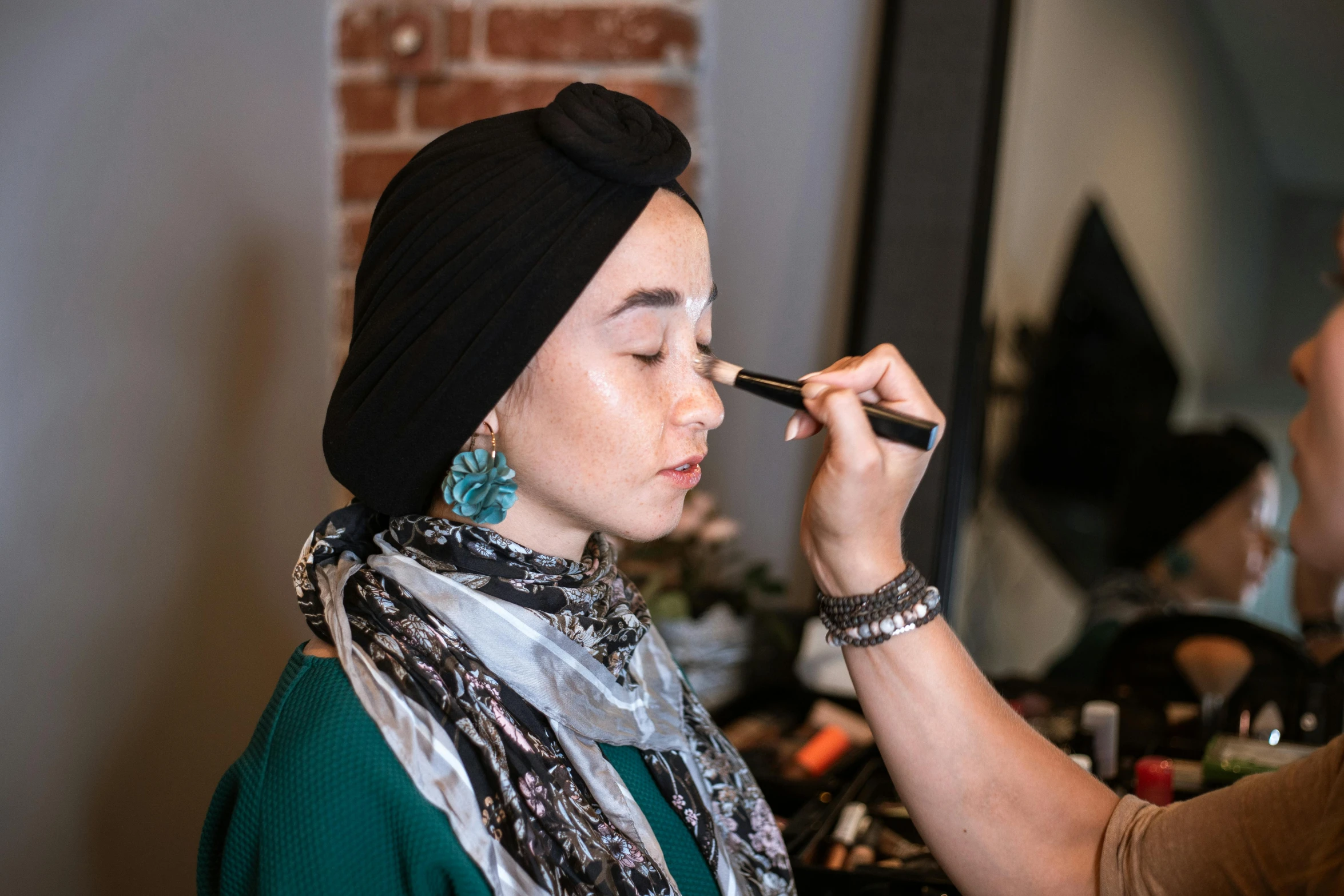 a woman is getting her make up done, by Meredith Dillman, hurufiyya, wearing a head scarf, complimentary eyeliner, profile image, relaxed eyebrows