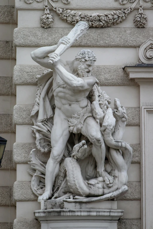 a statue that is on the side of a building, inspired by Hercules Seghers, neoclassicism, brandishing powerful sword, menacing statues, austrian architecture, snake man