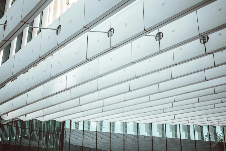 a clock on a pole in front of a building, inspired by Zaha Hadid, unsplash, light and space, office ceiling panels, interior of a library, rectangle, canopies