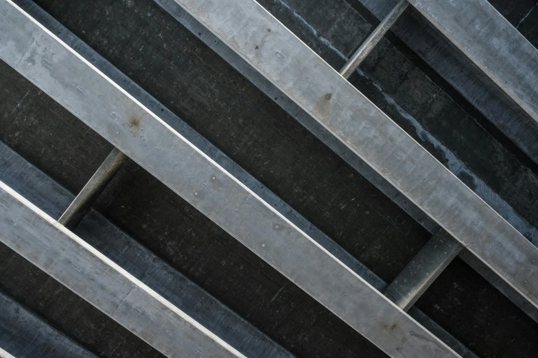 a man riding a skateboard up the side of a ramp, inspired by Donald Judd, unsplash, brutalism, detail texture, steel plating, godbeams, grey