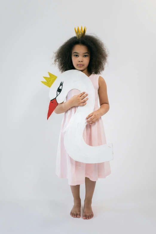 a little girl in a pink dress holding a paper swan, full product shot, large tall, white wearing, lookbook