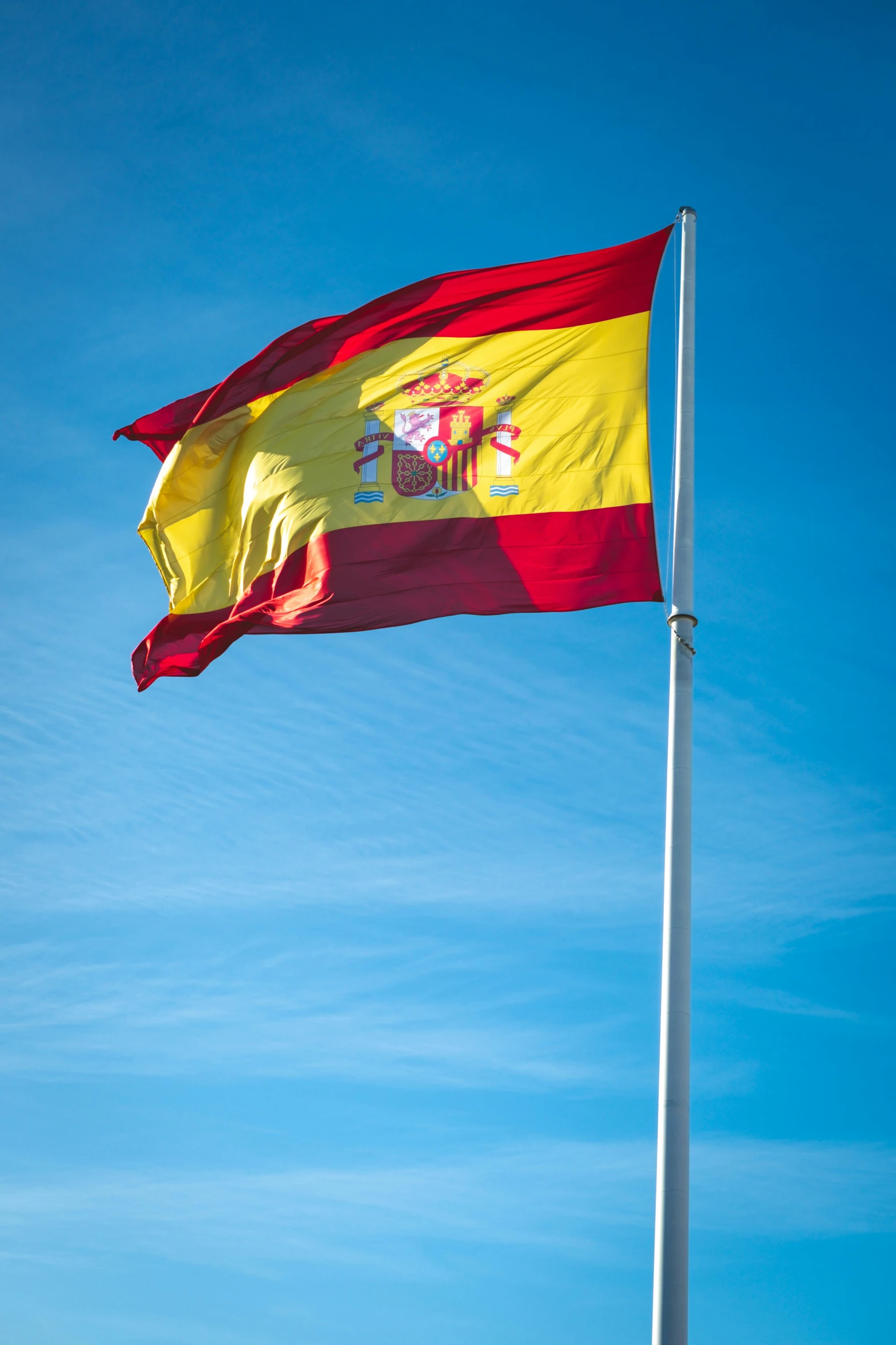 the spanish flag is flying high in the sky, unsplash, square, low quality photo, jerez, freezing