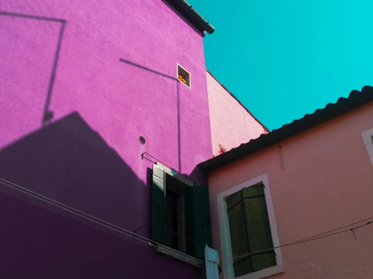 a pink building with a blue sky in the background, inspired by Carlo Maderna, pexels contest winner, neo-fauvism, venice biennale, second colours - purple, shady alleys, light and shadow