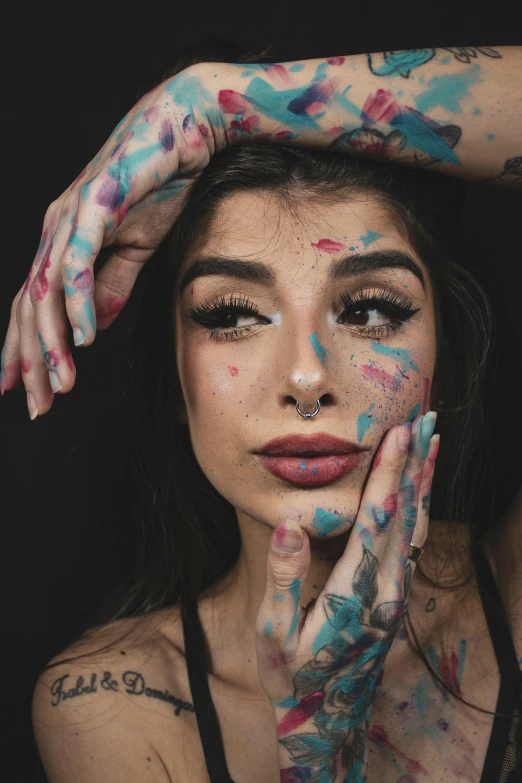 a woman with tattoos covering her face and hands, a colorized photo, inspired by Elsa Bleda, trending on pexels, woman portrait made out of paint, madison beer girl portrait, paint drops, attractive face and body